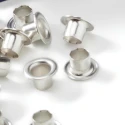 Small silver-coloured decorative eyelets 4 mm in diameter